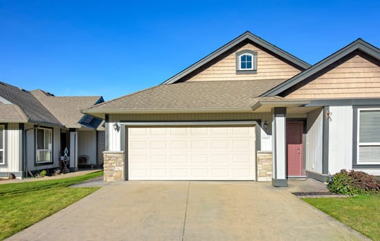 Wide garage of a nice residential house on bright winter day in British Columbia, Canada.