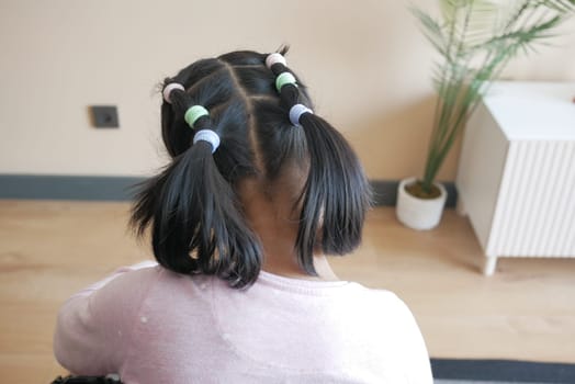 Beautiful ribbon is tied on a child hair .