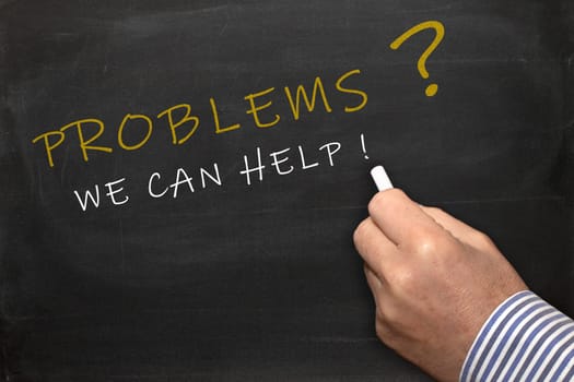 Problems - we can help - female hand with chalk writing text on blackboard