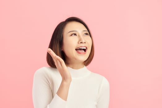 closeup beautiful young Asian woman with showing gesture over pink background