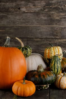 Many various colorful pumpkins over wooden background, Halloween or Thanksgiving day concept