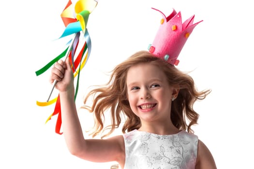 Beautiful little Halloween candy princess girl in crown holding pinwheel and smiling