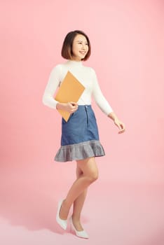 Young Asian woman holding the file standing on the white background.