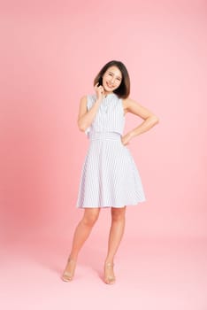 Full length photo of cheerful positive girl have fun on summer party event dance raise fingers up wear casual style clothing isolated over pink background