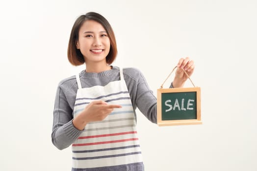 Woman finger point to chalkboard and showing sale word
