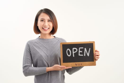 Portrait of young beautiful Asian cafe owner holding open sign