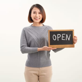 Portrait of young beautiful Asian cafe owner holding open sign