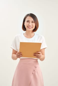A woman is holding and giving a big brown envelope with blank space on it