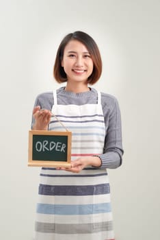 Young asian women barista holding chalkboard menu on white
