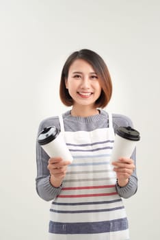 Close up photo beautiful amazing her she lady waitress owner cafeteria hold hands arms paper cups hot beverage invite visit cafe wear apron isolated white background