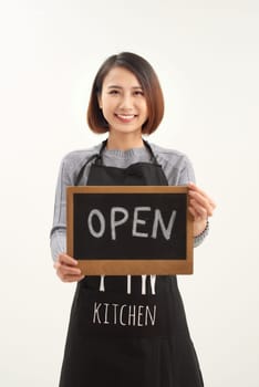 Portrait of young beautiful Asian cafe owner holding open sign