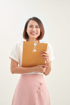 Woman hand holding brown envelope on white background