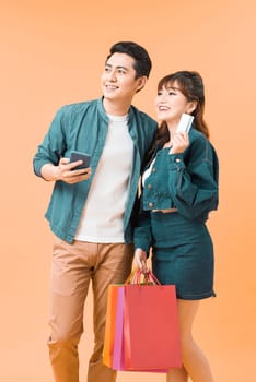 Young cute couple is excited about online shopping with credit card