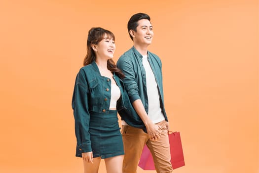 Couple with shopping bags. Studio shoot
