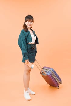 Young travelling woman isolated on color background