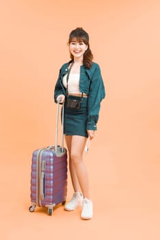Young beautiful female walking with the travel bag and passport