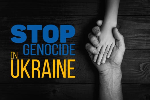male hands hold childrens on a dark background with words stop genocide in ukraine black and white color. concept needs help and support, truth will win