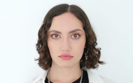A stunning portrait of a young woman with curly hair, highlighting her beauty and unwavering confidence