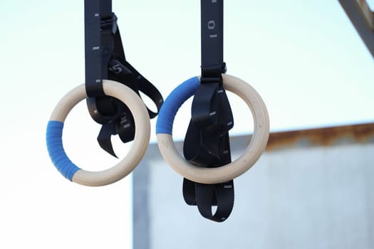 Sturdy wooden gymnastics rings designed for strength training, ideal for workouts and fitness enthusiasts alike
