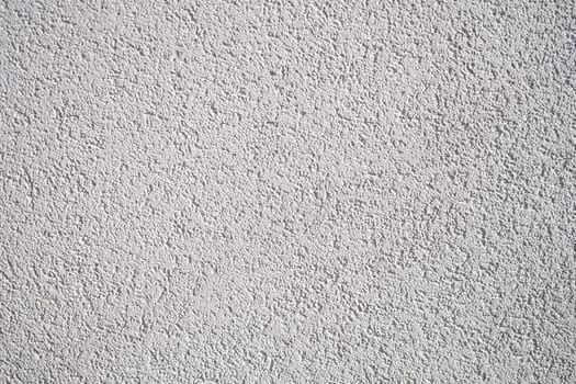A detailed closeup of a light gray textured wall surface that beautifully showcases intricate patterns and designs