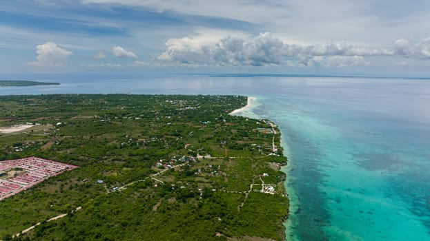 Beautiful beach, palm trees by turquoise water view from above. Bantayan island, Philippines.