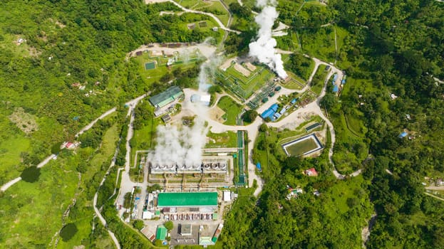 Aerial view of geothermal power plant with smoking pipes and steam. Renewable energy production at a power station. Negros, Philippines.