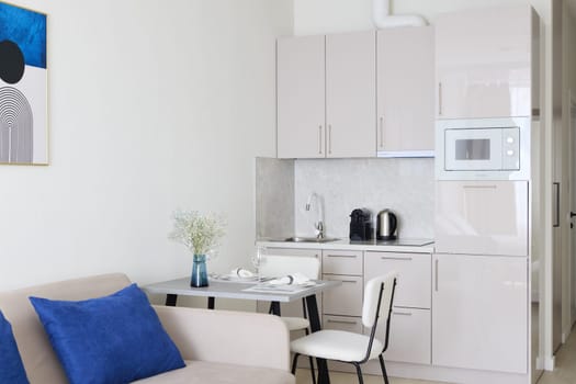 Stylishly designed and compact living area that features a modern kitchenette and cozy, inviting decor