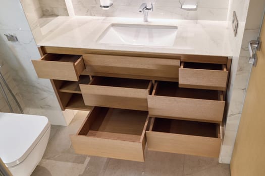 This sleek and stylish bathroom vanity is designed with multiple open drawers to ensure organized storage solutions