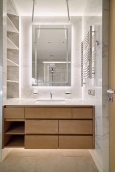 This modern bathroom features stylish fixtures and ambient lighting, creating a serene and calming atmosphere