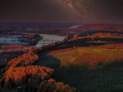 France, Gironde, Haut-Langoiran, Aerial view of the vineyard and wooded areas of Chateau de Langoiran in the Bordeaux vineyards at night. High quality photo