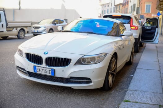 Cremona, Itally - October 6th 2024 A white bmw z4 sdrive28i roadster parked with the top down on a european city street, embodying elegance, style, and a sense of freedom