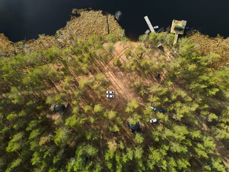An aerial view beautifully showcasing a tranquil and peaceful campsite nestled amidst lush greenery and calm waters