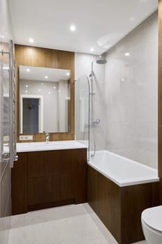 This stylish and modern bathroom showcases a luxurious shower, a spacious bathtub, and beautifully sleek cabinetry
