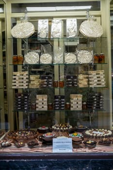 Cremona, Italy - November 20th 2024 Delicious assortment of nougat, torrone, honey, and chocolates displayed in a shop window in cremona, italy, enticing passersby with local delicacies