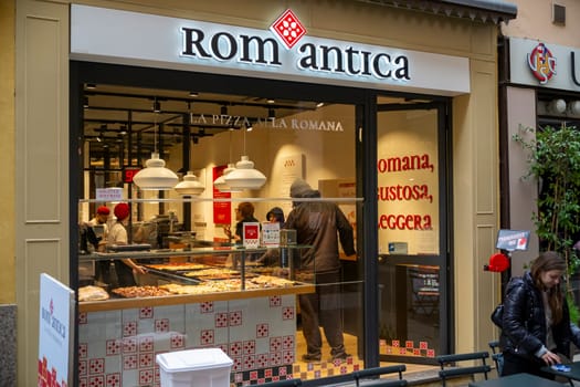 Cremona, Italy - November 20th 2024 Chefs preparing and serving pizza al taglio at romantica pizzeria in cremona, italy