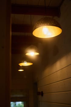 Charming pendant lights gracefully illuminate a serene hallway, creating an inviting and modern touch to the space
