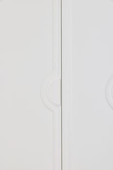 A sleek and modern double door cabinet featuring a minimalist white design, ideal for enhancing any interior space