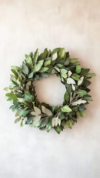 Green leaf wreath on textured wall, rustic home decor concept.