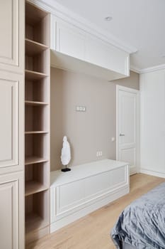 This elegant bedroom showcases sleek builtin storage solutions alongside a minimal decor aesthetic