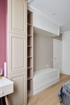 This stunning sleek modern bedroom showcases elegant builtin cabinetry along with a calming and soothing color palette