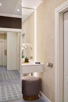 A chic contemporary hallway featuring soft lighting and elegant furnishings for an appealing aesthetic
