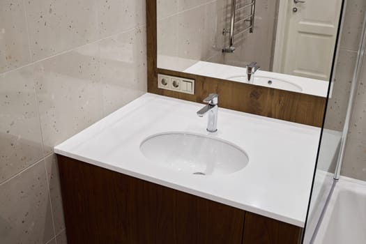 A stylish and modern bathroom design that showcases a sleek vanity, an elegant mirror, and a contemporary faucet