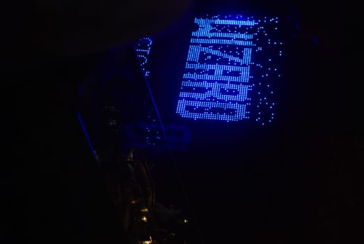 A vibrant blue sign shining brightly and reading WIZARD stands out beautifully at night, ideal for magical themes