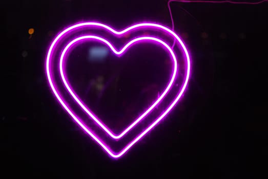 A stunning and vibrant violet neon heart light, perfect for adding a romantic touch to any living space