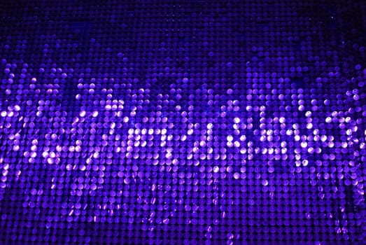 A dazzling and shimmering purple sequin backdrop that is perfect for various designs, events, and creative projects