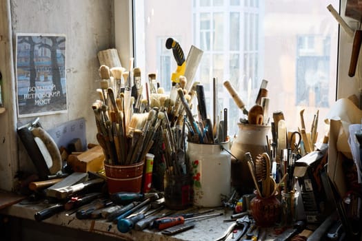 A creative workspace that is filled with a variety of art tools and vibrant brushes, perfect for all artists