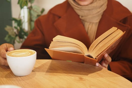 A closeup of a person enjoying a book in a warm, comfy atmosphere, escaping the world