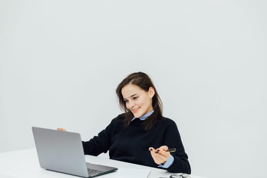 woman learning online laptop in office at desk