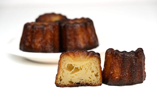 Caneles de bordeaux, traditional French sweet dessert with white table background, High quality photo