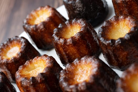 Caneles de bordeaux, traditional French sweet dessert with white table background, High quality photo
